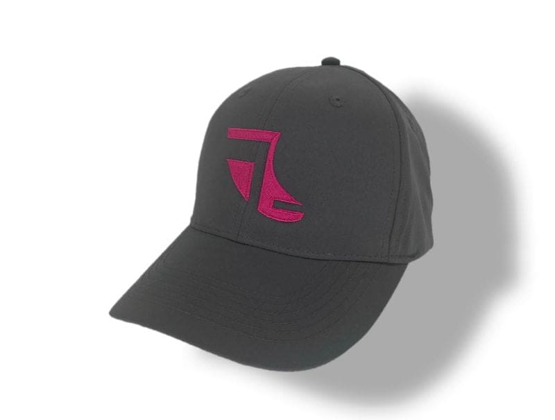 Angled image of Grey ShoreTees Baseball Cap with Pink embroidered Fin Logo